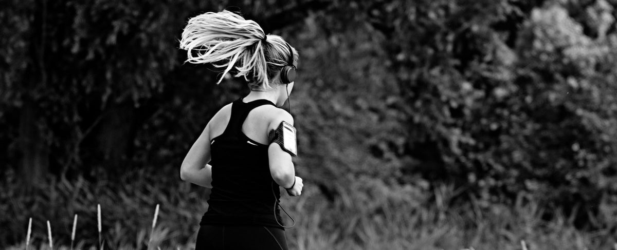 Joggerin mit Kopfhörer in der Natur